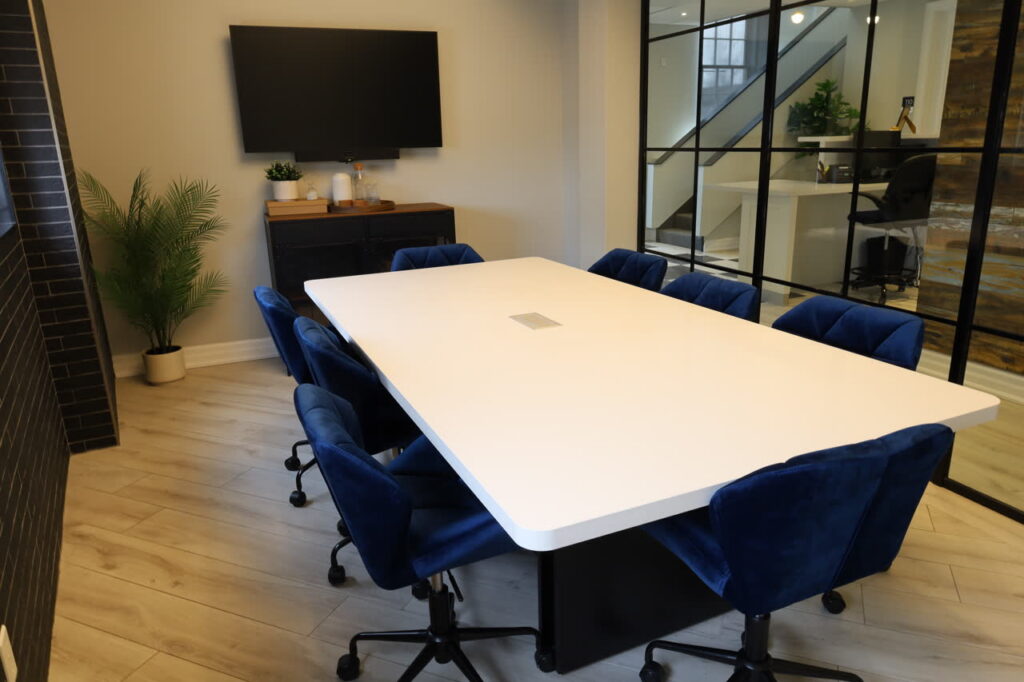 A conference room with a TV in the background.