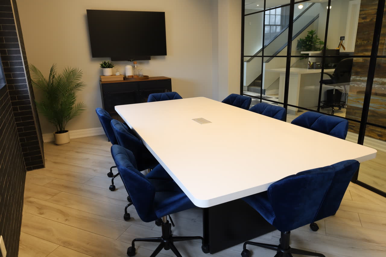 A conference room with a TV in the background.